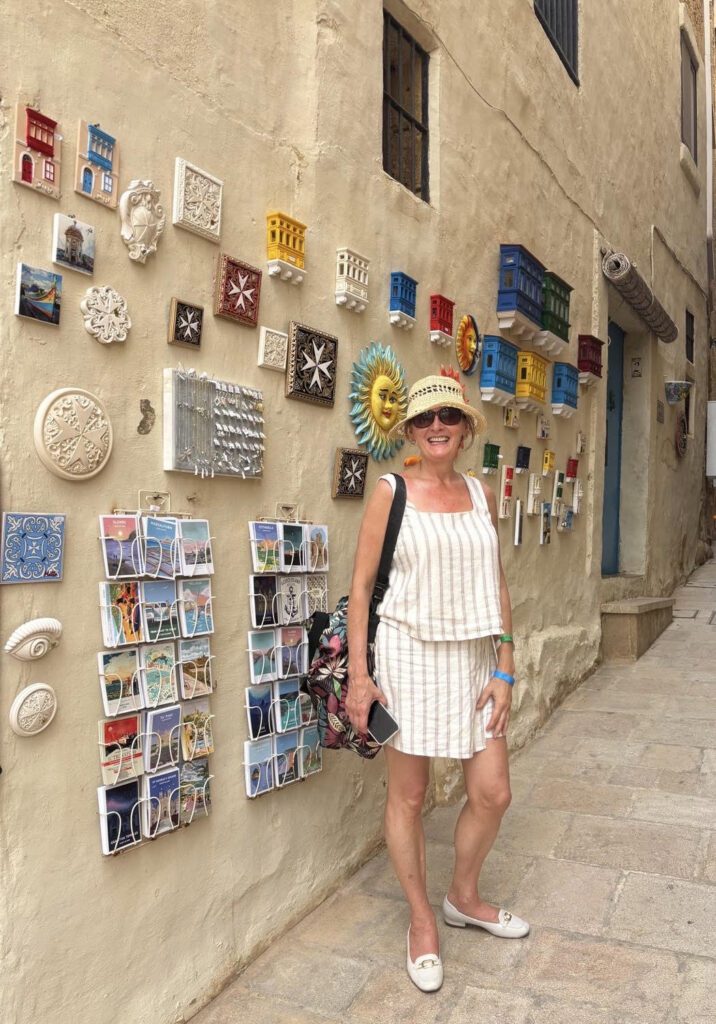 Anna of ASR Interior Designs exploring colorful architectural and decorative details in Malta.